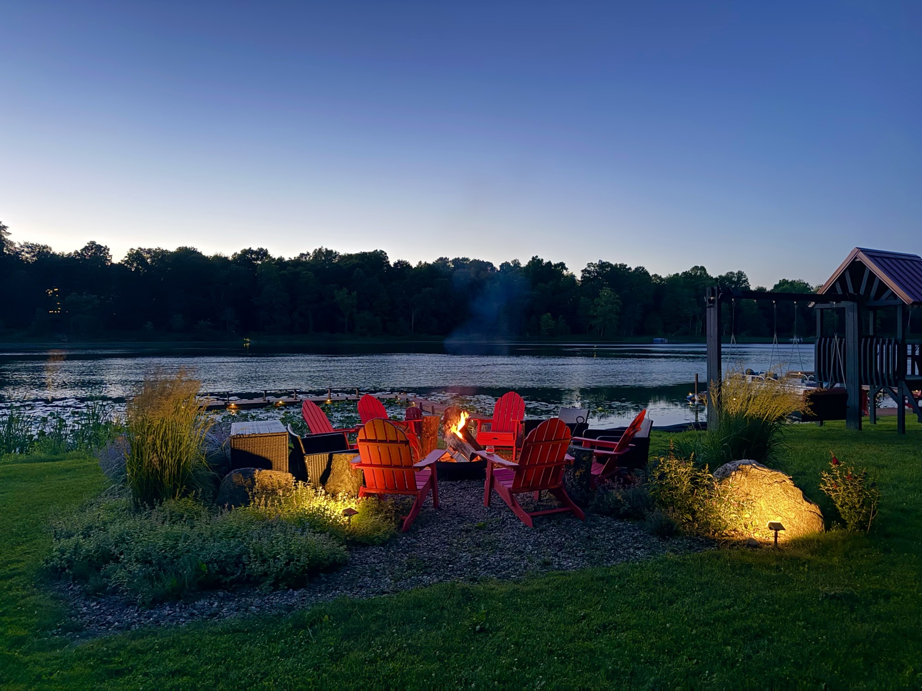 Lakeside fire pit glowing at dusk