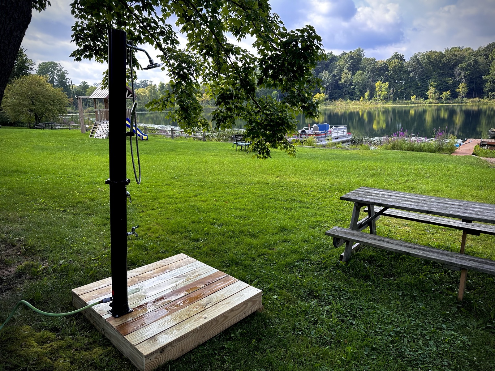 The lakeside outdoor shower on its cedar platform overlooking the water