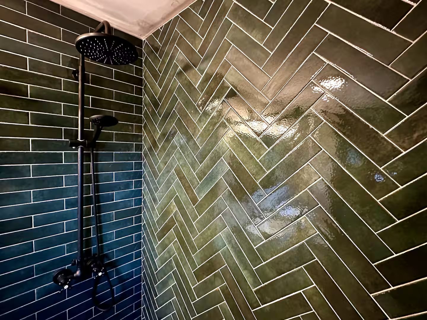 Green herringbone tile shower